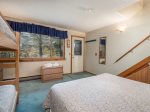 Bedroom on lower level with queen size bed and set of bunks
